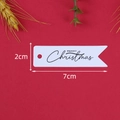 Dettaglio di un'etichetta natalizia in carta bianca con dimensioni 2cm x 7cm su sfondo rosso - Confezione da 100 / Bianco