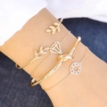 Detail of four-piece gold bracelet set with leaf and knot designs worn by a model - Leaf Knot Geometric Set (10593)