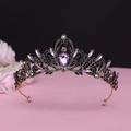 Macro view of vintage baroque crown featuring purple pear-shaped crystal and black diamonds - No.1 Antique Gold (Purple Stone)