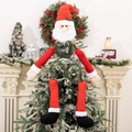 Dettaglio del puntale per albero Babbo Natale con cappello rosso e gambe di peluche - Babbo Natale