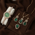 Golden quartz watch and jewelry set with green teardrop stones on brown silk fabric - Green Waterdrop Jewelry Set