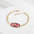 Detail of 18K gold-plated Capricorn bracelet with red enamel and blue stones - Capricorn