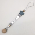 Close-up of baby pacifier clip with wood beads, silicone crown, and BABY letter charms - Gray
