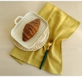 Close-up of a white rectangular ceramic plate with a yellow cotton napkin and straw mat - 40*40cm / Yellow