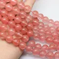 Handheld view of natural translucent pink crystal round beads with fine textures - Watermelon red / 4mm (approximately 90 Beads) 38cm Long