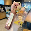 Milk tea bear keychain featuring yellow liquid charm with gold bell and brown strap - Bear Milk Tea - Water Bucket Style
