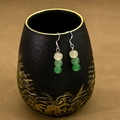 Detail of beaded water drop earrings with green beads on a black ceramic stand - E2735-2/White Green Beaded