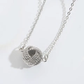 Elegant silver necklace featuring a detailed woven knot pendant in polished metal finish - Silver Round