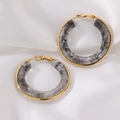 Close-up of gold-plated C-shaped resin hoop earrings with grey marble texture finish - Gray