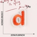 Orange embroidered letter D patch with beige border, size 2.5cm by 2cm for school uniforms - Letter-D