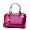 Glossy magenta patent leather Boston handbag with gold woven handles and zippers - Rose Red