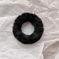 Close-up of soft black plush scrunchie with faux rabbit fur texture on white background - Black