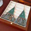 Close-up of bohemian triangle tassel earrings with turquoise beads on a velvet jewelry box - Triangle Tassel Earrings / Green