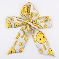 Polyester silk hair scarf with yellow smiley faces and Keep Going text in a bow tie shape - S29-Yellow Smiley Face Inspirational