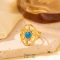 Golden sunburst ring in stainless steel with a blue stone inlay on a luxury background - Adjustable Open / Gold Split Hollow Sun Pattern with Round Blue Stone (JOM25012)