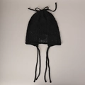 Close-up of black crochet knit beanie featuring hollow-out patterns and tie straps - M (56-58cm) / Black