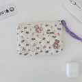 Macro view of floral quilted cotton bag with teddy bear pattern and purple cord zipper - Purple Flower Toy Bear