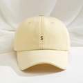 Close-up of premium twill cotton fabric and black letter S embroidery on cream baseball cap - One Size / Goose Yellow