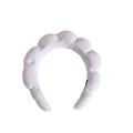 Close-up of white sponge padded headband made of soft terry towel fabric for washing face - Single Headband / White