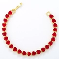 Detail of elegant gold heart bracelet with continuous red heart-shaped gemstones - Gold Magenta Zirconia Bracelet