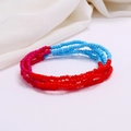 Detail of red and light blue beaded waist chain layers on white fabric texture - #28(Red Blue Contrast)