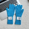 Detail of blue knitted wool gloves with vintage white fabric label on the ribbed cuff - One Size / Lake Blue