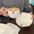 Hand-painted ceramic coffee cup with heart pattern and latte art in a cozy setting - Matte Large Heart
