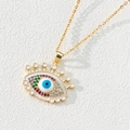Macro shot of evil eye pendant with white enamel, colorful zircons and gold chain - Style J-White Enamel Multi-color Eye