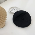 Classic black wool beret hat in minimalist style shown on a white tabletop setting - M(56-58cm) / Black