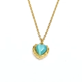 Macro detail of a 18k gold plated necklace with a vintage heart blue cat eye stone - Gold Lake Blue Cat Eye Stone