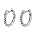 Macro shot of silver huggie hoop earrings featuring pavé set sparkling clear zircons - Silver White Stone