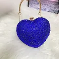 Close-up of heart-shaped evening bag with deep blue rhinestones and gold ring handle - Sapphire Blue