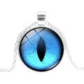 Detailed close-up of a silver dragon eye pendant with a unique blue glass cabochon - Silver Base - Blue Eye