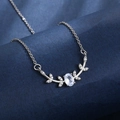 Silver reindeer necklace with oval pearl and leaf details on deep blue background - Thick White K-406