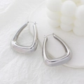 Macro shot of large silver geometric triangular earrings with a polished metal finish - Geometric Triangle Style (CK224) / Steel