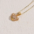 Golden necklace featuring a pink cubic zirconia paved bear pendant on a textured surface - 14K Gold Pink Zircon