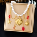 Detail of vintage gold sun and moon pendants on a pearl chain necklace display - Sun Moon Star Style (N3661)