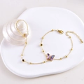 Golden hand chain ring bracelet featuring a purple gradient butterfly and colorful beads - Black & White Zirconia Butterfly