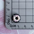 Detailed top view of a 1.2cm black resin donut miniature with pink icing and sprinkles - 10-Yellow Cream Black Pink Donut