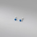 Macro shot of 999 sterling silver stud earrings with blue gemstone in four-prong setting - 999 Fine Silver Pair - 2mm Blue Zirconia