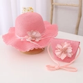 Close-up of pink straw sun hat and matching crossbody bag with floral decorations - Hat + Bag Set / Watermelon red