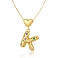 Detailed view of the gold heart pendant and colorful zircon K letter necklace charm - Letter K