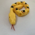 Articulated yellow plastic snake toy with realistic pattern and flexible joints - Yellow