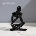 Modern abstract resin thinker statue in matte black finish, sitting and reading a book - Black Right Reading