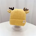 Yellow knitted baby beanie with reindeer antlers and ear flaps for winter warmth - 45-52cm / Yellow