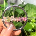 Silver circular hair clip featuring colorful natural crystal stones in a handheld view - Silver Circle Mixed Color Chips