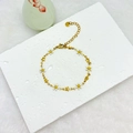 Detail of 18k gold plated stainless steel daisy and star bracelet on stone background - White Gold