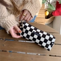 Corduroy checkerboard pencil case held by hands in a warm sunny outdoor setting - Black Check