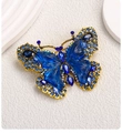 Close-up of vintage butterfly brooch with deep blue crystals and gold-toned alloy plating - Dark Blue Butterfly