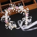 Macro shot of handmade bridal floral headband with pearls, fabric flowers and satin ribbons - Pearl Flower Headband - Pink